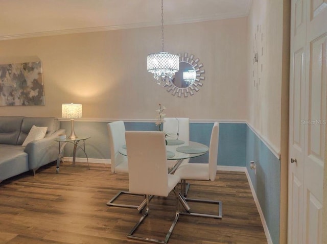 dining area featuring wood-type flooring and ornamental molding