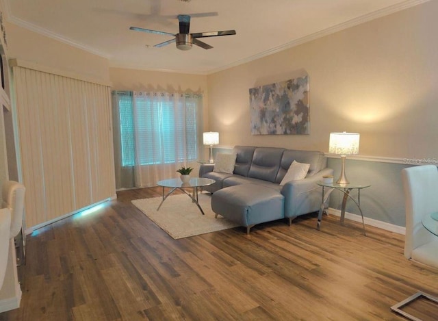 living room with ornamental molding, ceiling fan, and dark wood-type flooring