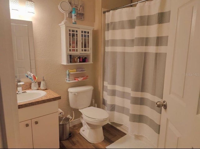 bathroom featuring hardwood / wood-style floors, vanity, and toilet