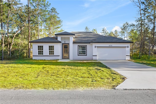 view of front of home with a garage and a front yard