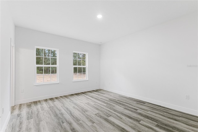 unfurnished room with light hardwood / wood-style flooring