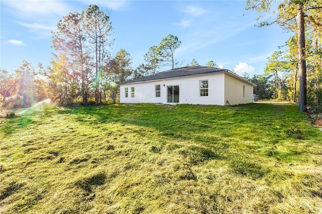 back of house featuring a lawn