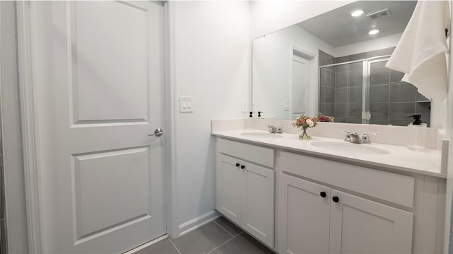 bathroom with walk in shower, tile patterned flooring, and vanity