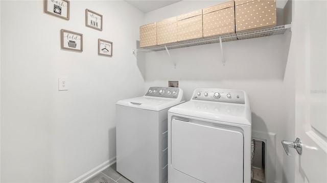 laundry room with tile patterned flooring and washing machine and dryer