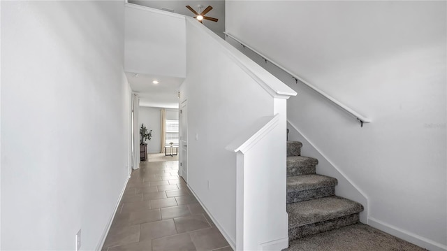 stairs featuring ceiling fan