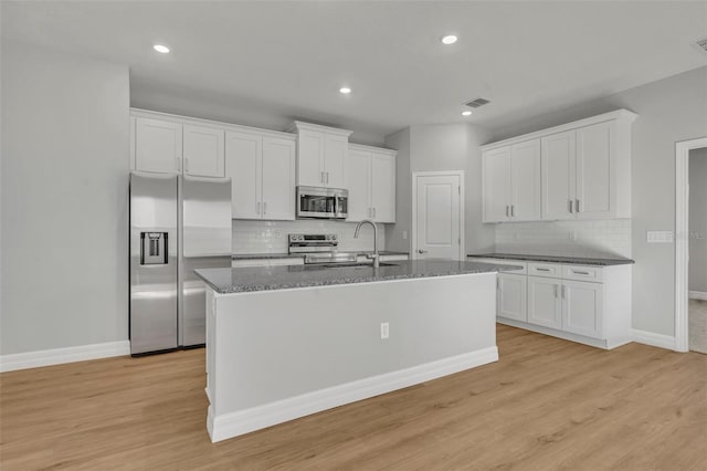 kitchen featuring white cabinets, stainless steel appliances, light hardwood / wood-style floors, and sink