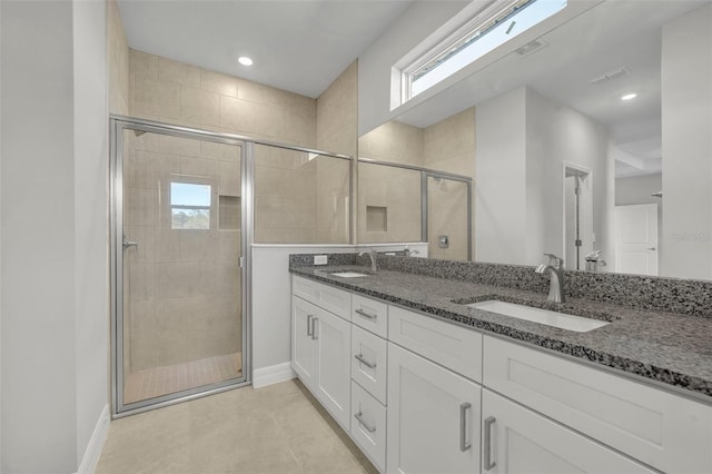 bathroom with tile patterned flooring, vanity, and an enclosed shower