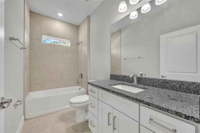 full bathroom featuring tile patterned flooring, vanity, toilet, and tiled shower / bath