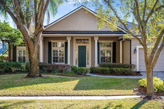 view of front of property with a garage and a front lawn