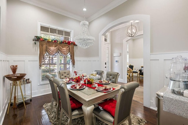 dining area with ornamental molding, dark hardwood / wood-style floors, and a notable chandelier