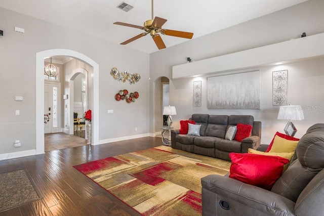 living room featuring dark wood-type flooring and ceiling fan