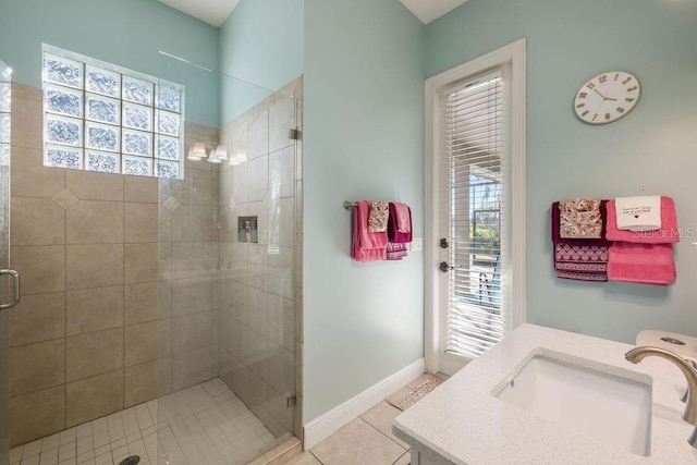 bathroom featuring vanity, tile patterned floors, a wealth of natural light, and a shower with door