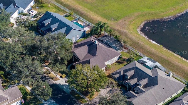 birds eye view of property with a water view and a residential view