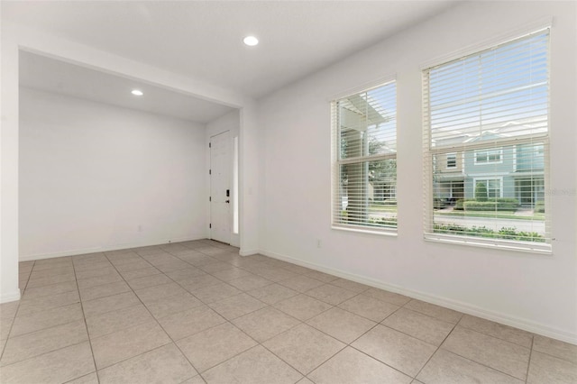 tiled empty room featuring a healthy amount of sunlight