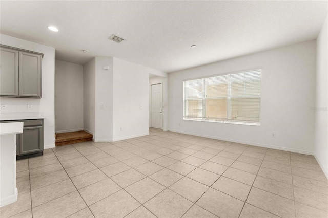 unfurnished living room with light tile patterned floors