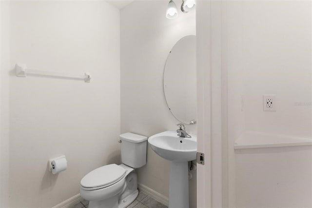 bathroom featuring tile patterned floors and toilet