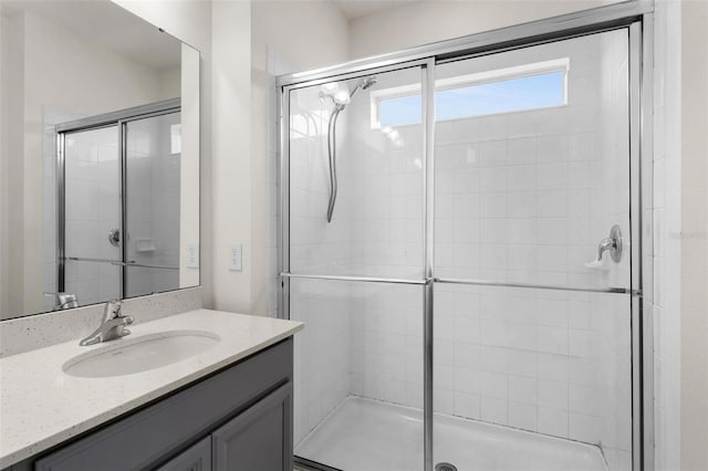 bathroom featuring vanity and an enclosed shower