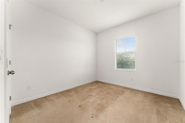 empty room featuring light carpet