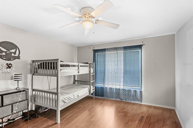 unfurnished bedroom with ceiling fan and wood-type flooring