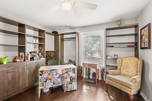 living area with ceiling fan and dark hardwood / wood-style flooring