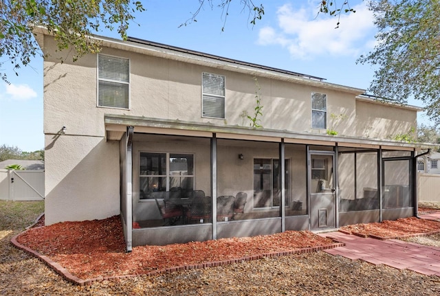 back of house with a sunroom