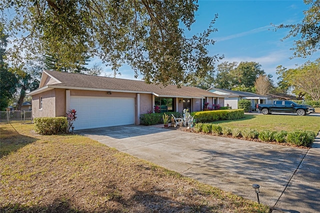 single story home featuring a garage and a front lawn