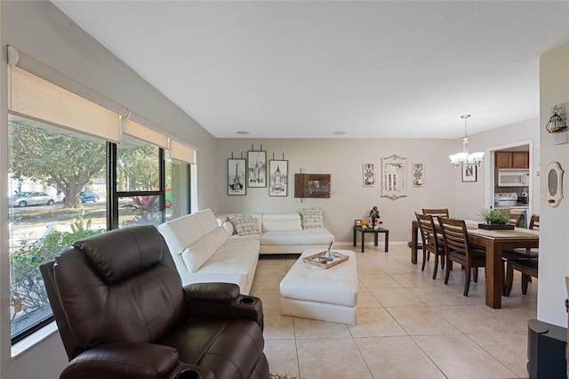 living room featuring a notable chandelier and light tile patterned floors