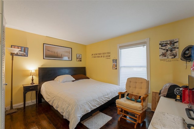 bedroom with dark hardwood / wood-style floors