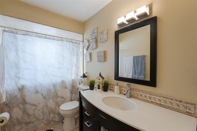 bathroom with tile patterned floors, curtained shower, vanity, and toilet