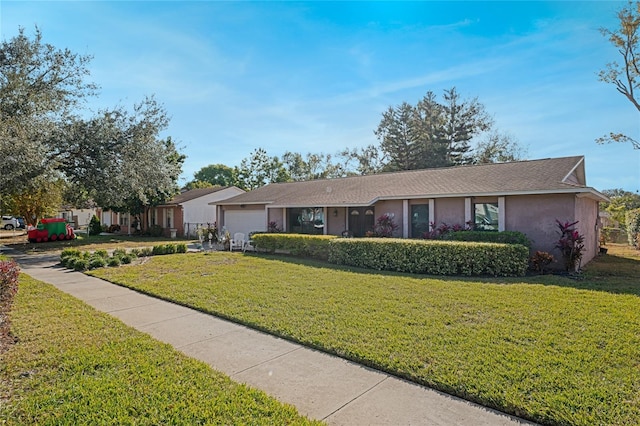 ranch-style home with a front yard and a garage