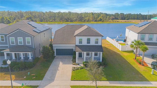 view of front facade with a garage, a water view, and a front yard