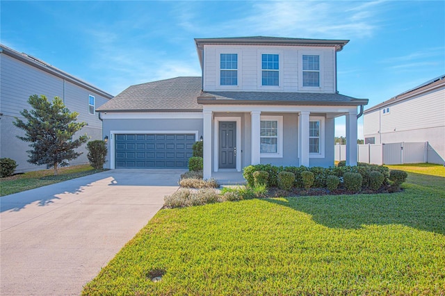 front of property featuring covered porch, a front yard, and a garage