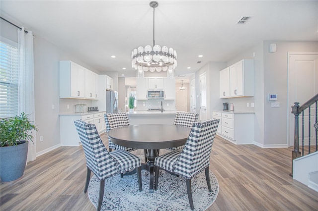 dining room featuring hardwood / wood-style flooring and a notable chandelier