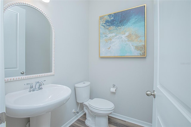 bathroom featuring sink, hardwood / wood-style floors, and toilet