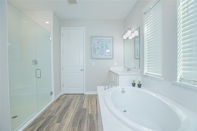 bathroom featuring vanity, separate shower and tub, and wood-type flooring