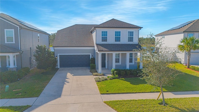 front of property featuring a front yard and a garage