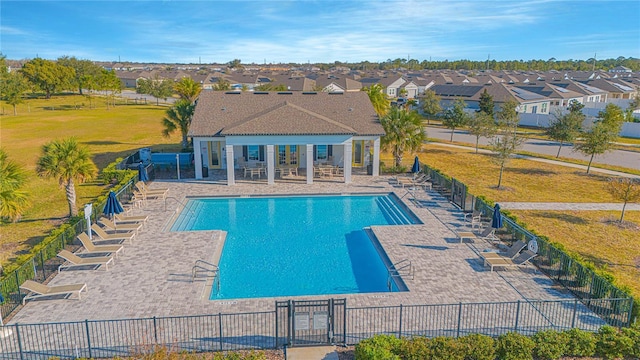 view of pool with a yard and a patio