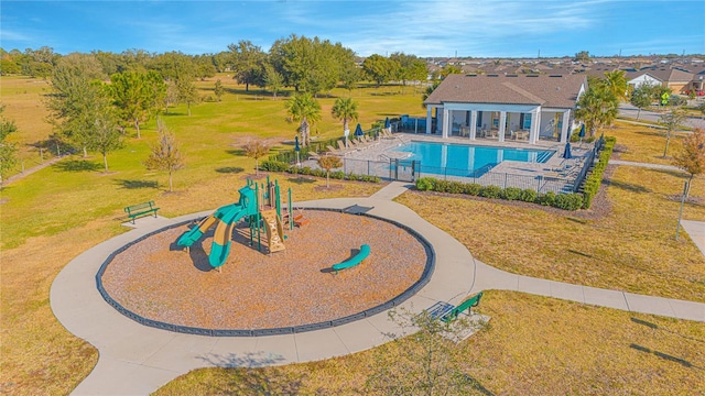 view of pool featuring a playground, a lawn, and a patio