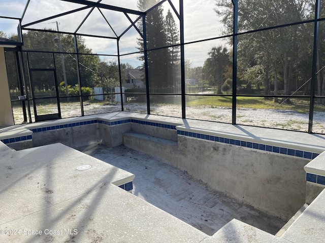 view of swimming pool with glass enclosure