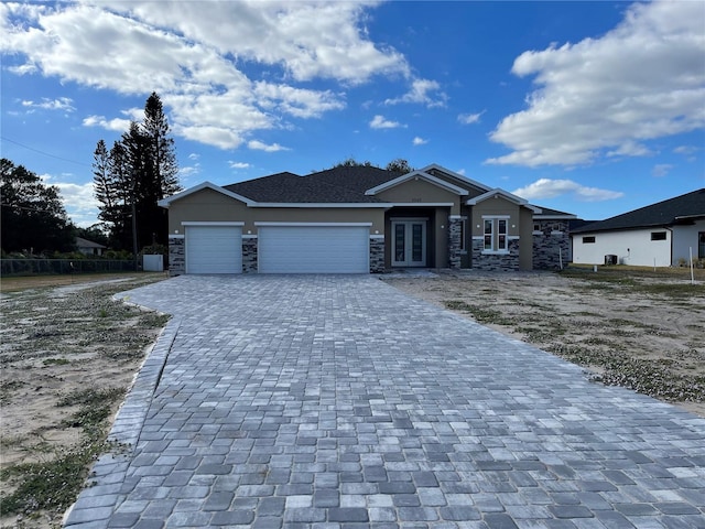 view of front of property with a garage and french doors