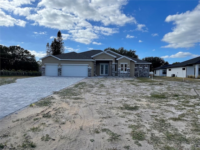 view of front of house with a garage and french doors