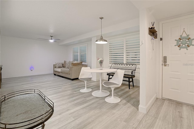 living room with ceiling fan and light wood-type flooring