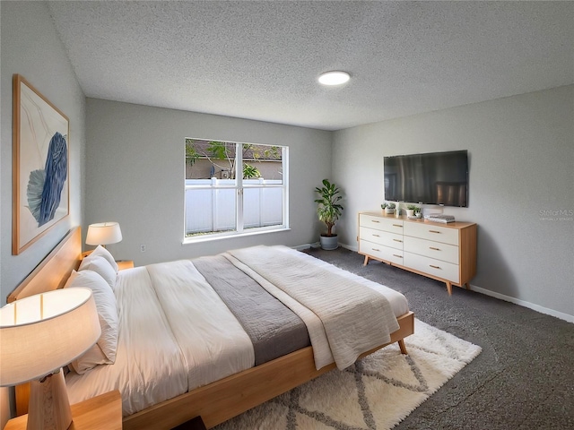 carpeted bedroom featuring a textured ceiling