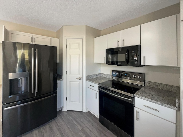 kitchen featuring light stone countertops, dark hardwood / wood-style floors, a textured ceiling, white cabinets, and black appliances