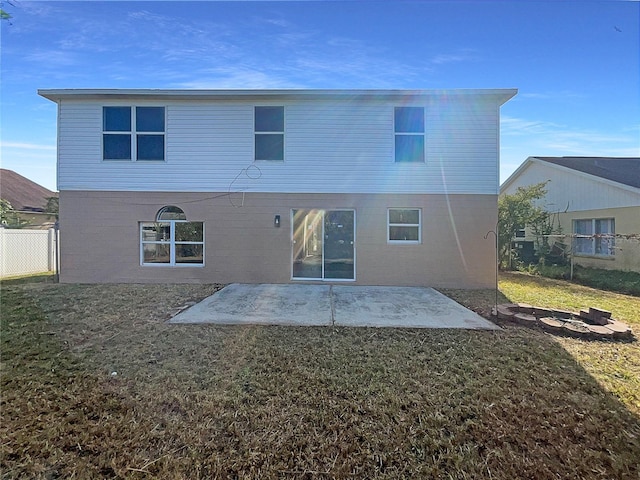 rear view of house with a yard and a patio