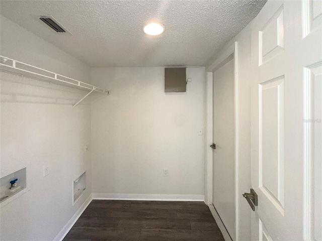 laundry area featuring dark wood-type flooring, a textured ceiling, and washer hookup