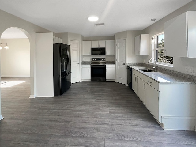 kitchen with white cabinets, sink, dark wood-type flooring, and black appliances