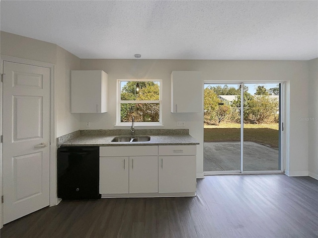 kitchen featuring sink, black dishwasher, dark hardwood / wood-style flooring, a textured ceiling, and white cabinets