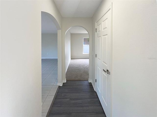 hall with dark tile patterned floors