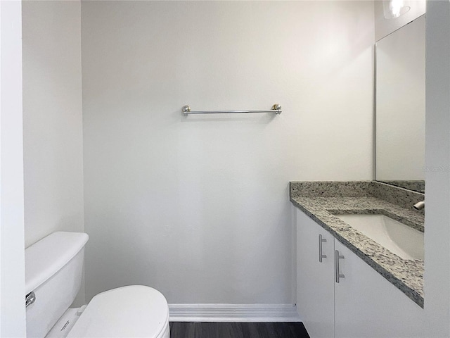 bathroom featuring hardwood / wood-style floors, vanity, and toilet